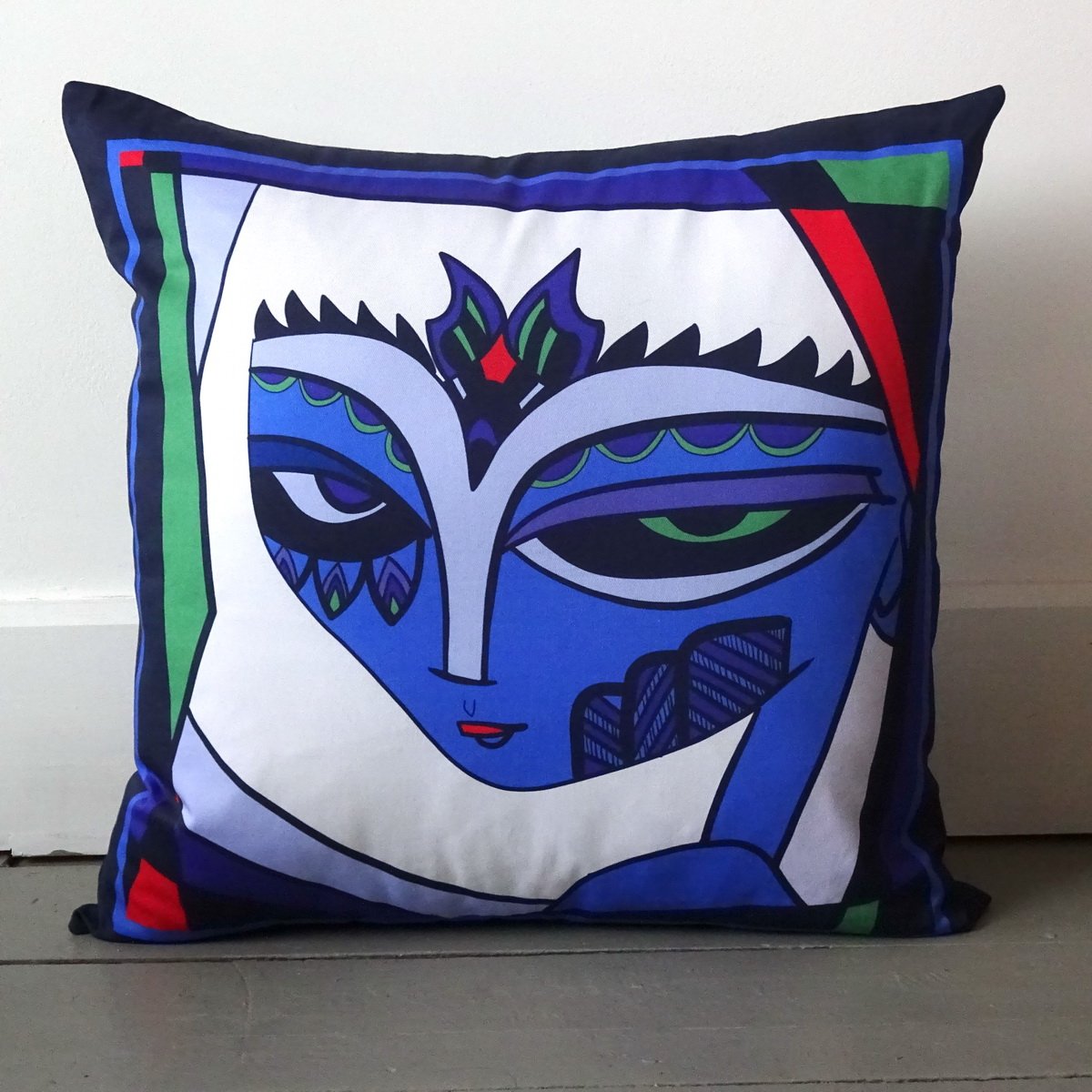Fiona the Fierce cushion Bright and collurful face with blues red purple and white. wicked imp designs